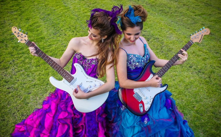 Quinceaneras playing the guitar together