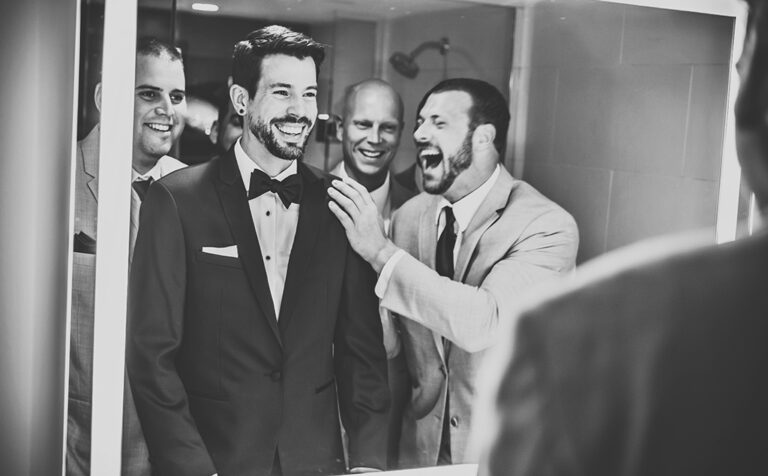 Candid shot with groomsmen ang groom in a bathroom