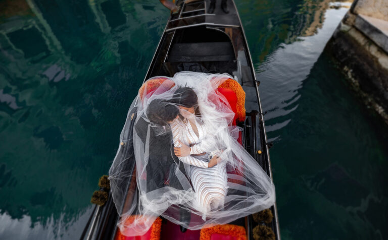 Wedding Couple in a Gondola at Venice Canal Italy